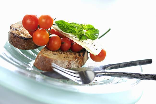 Toast with cherry tomatoes — Stock Photo
