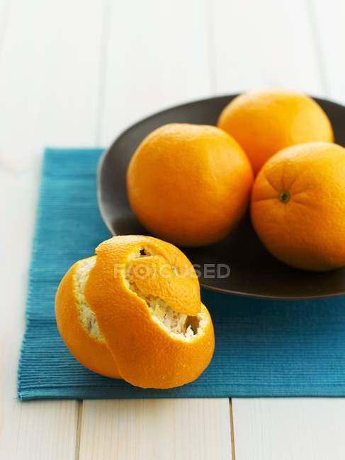 Fresh ripe Oranges on plate — Stock Photo