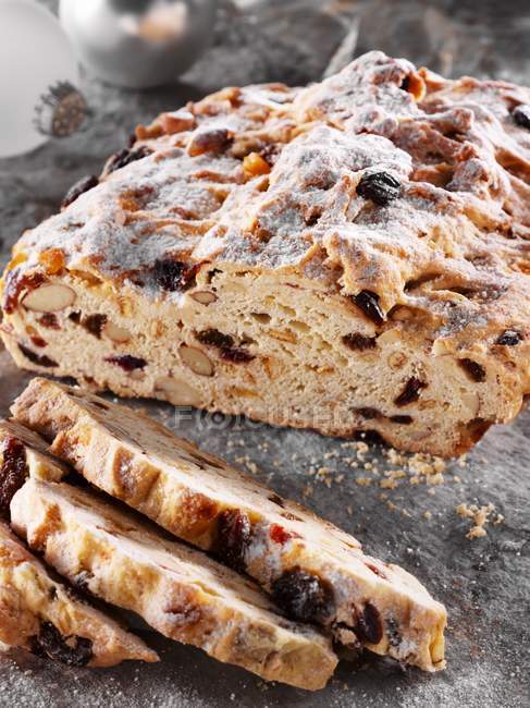 Partly sliced Christmas stollen — Stock Photo