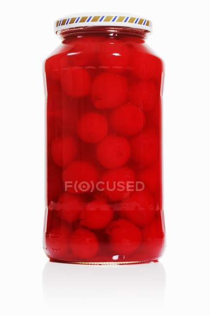 Jar of bottled cherries — Stock Photo