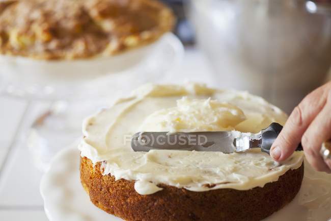 Frosting a Carrot Cake — Stock Photo