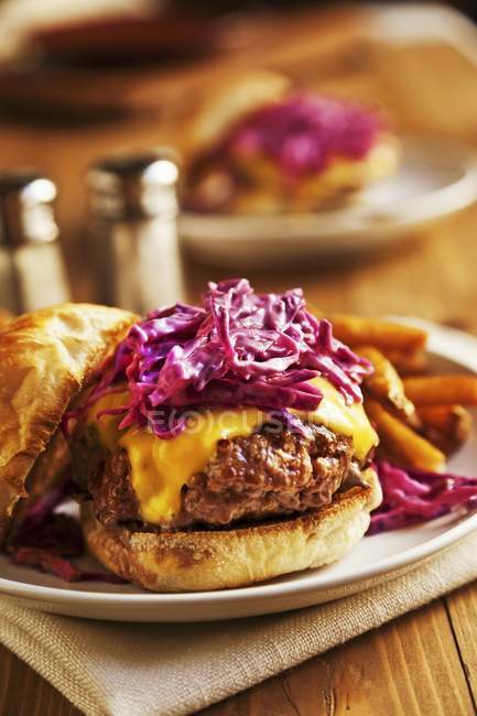 Cheeseburger topped with cabbage — Stock Photo