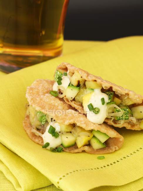 Summer Squash and Zucchini Taquitos over yellow towel — Stock Photo