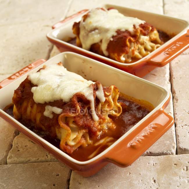 Rolled cheese lasagna with marinara sauce — Stock Photo