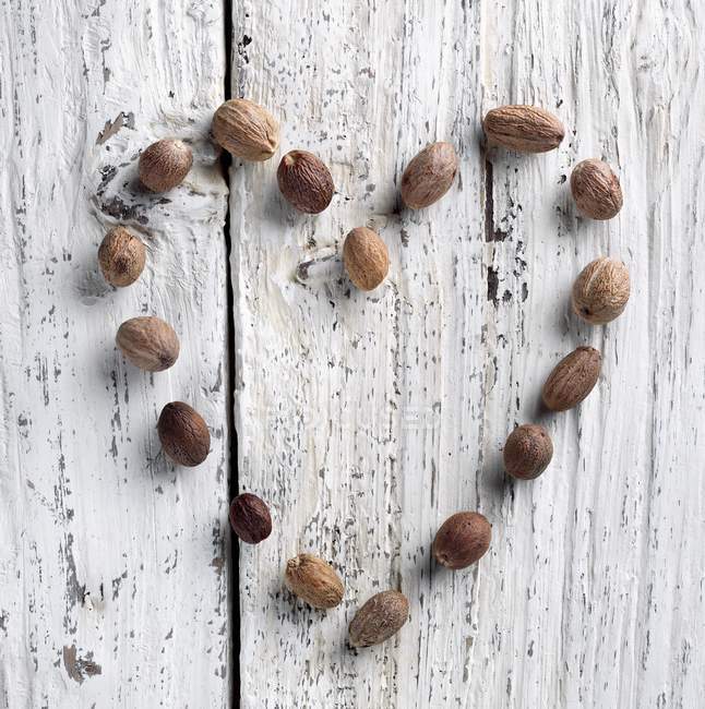 Forma de corazón con nutmegs - foto de stock