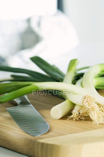 Spring onions and a knife — Stock Photo