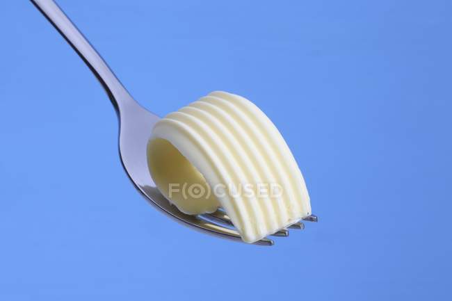 Vue rapprochée d'une boucle de beurre sur une fourchette — Photo de stock