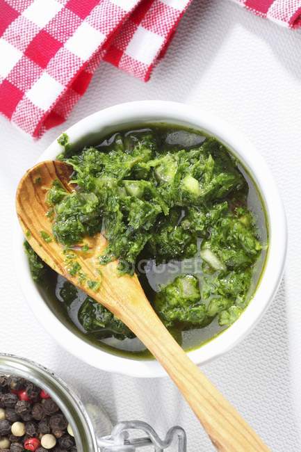 Top view of Chimichurri hot sauce with spoon in bowl — Stock Photo