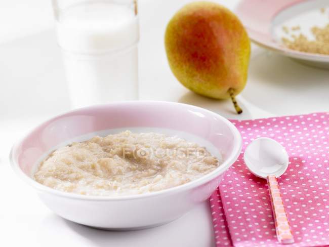 Rice pudding and pear — Stock Photo