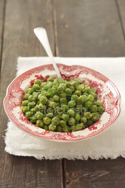 Peas with butter on textile — Stock Photo