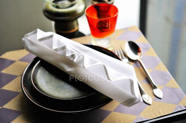 Elevated view of a place setting with an artistically folded napkin — Stock Photo