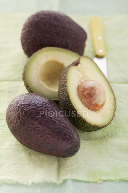 Avocado whole and in pieces — Stock Photo