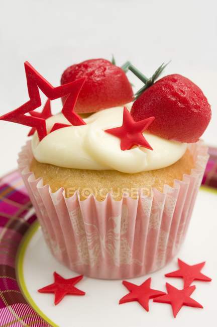Cupcake decorated with marzipan strawberries — Stock Photo