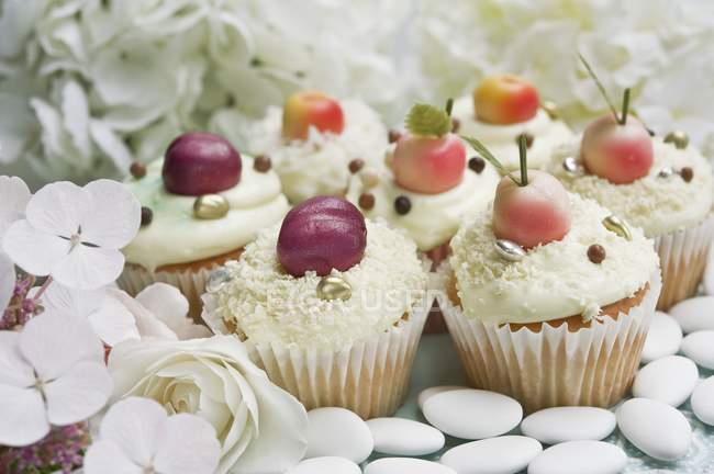 Cupcakes decorated with marzipan fruits — Stock Photo