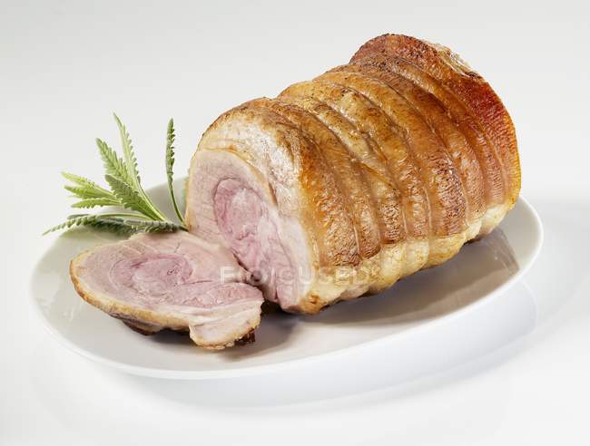 Partly sliced Rolled joint of pork — Stock Photo