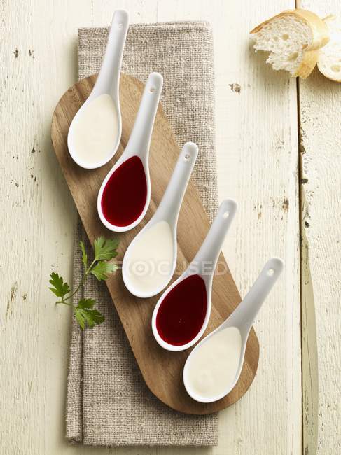 Kohlrabi und Rote-Bete-Creme in Porzellanlöffeln über Holztisch — Stockfoto