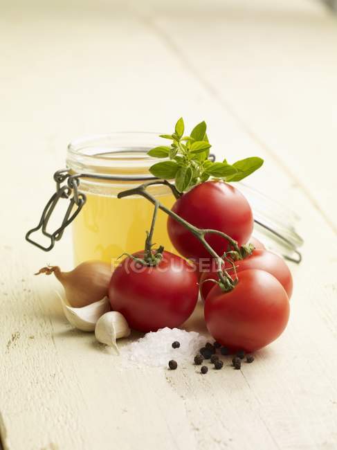 Ingredientes para sopa de tomate sobre superficie de madera blanca - foto de stock