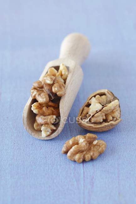 Walnuts and wooden scoop — Stock Photo