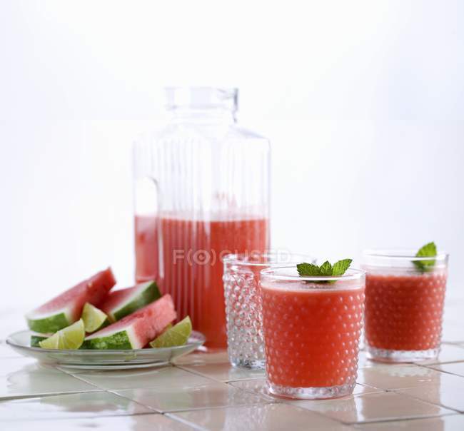 Squeezed watermelon juice in glassas and jar — Stock Photo