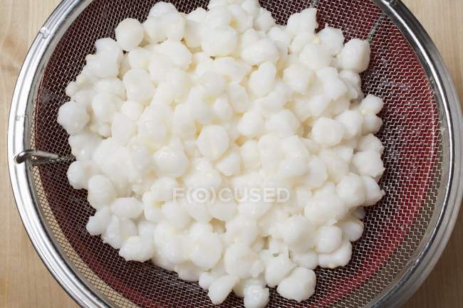 Closeup top view of fresh Hominy in a strainer — Stock Photo