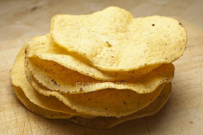Closeup view of stacked Tostadas on wooden surface — Stock Photo