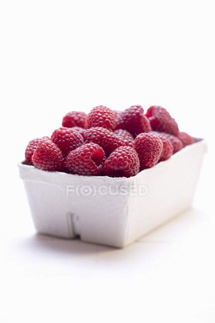 Raspberries in cardboard punnet — Stock Photo