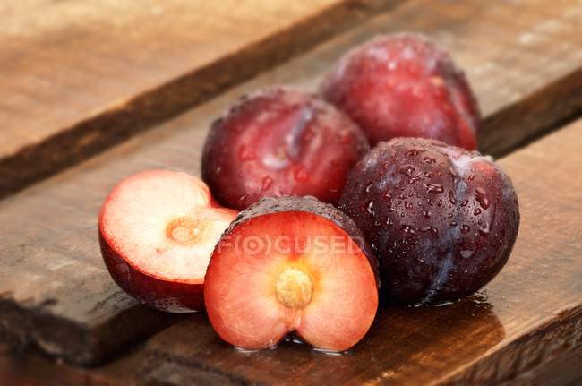 Freshly washed Plums with halves — Stock Photo