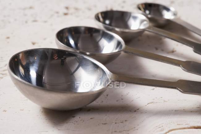 Closeup view of four measuring spoons — Stock Photo