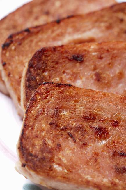 Closeup view of pan fried spam slices — Stock Photo