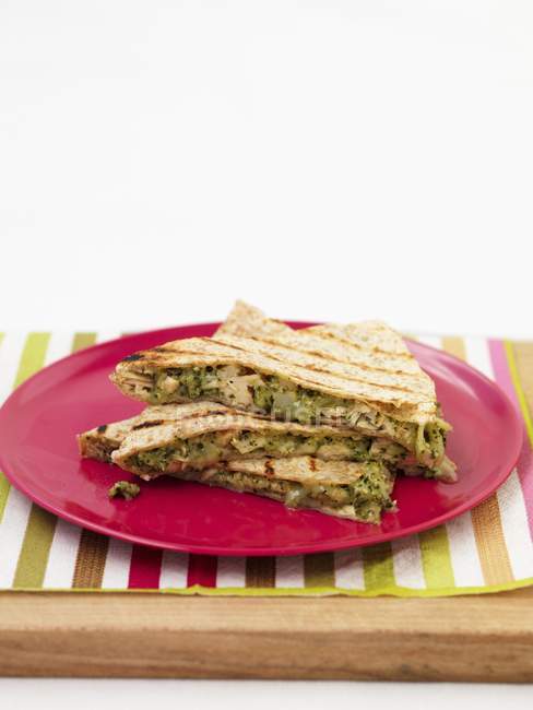 Closeup view of Quesadillas on a red plate — Stock Photo