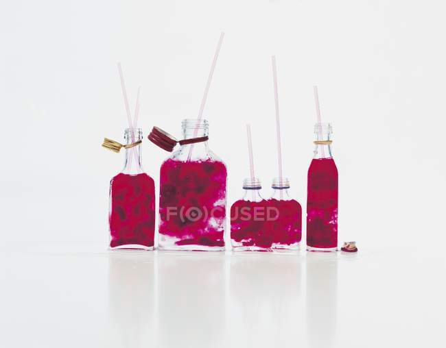 Bottles of red cherries — Stock Photo