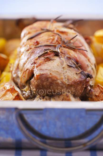 Turkey roulade with rosemary, vegetables and fruit in a roasting tin — Stock Photo