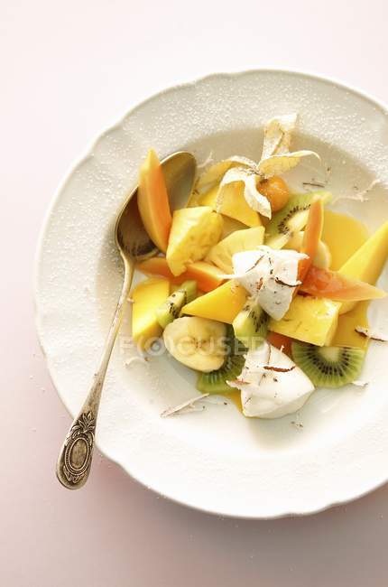 Closeup top view of fruit salad with yogurt dumplings and coconut — Stock Photo