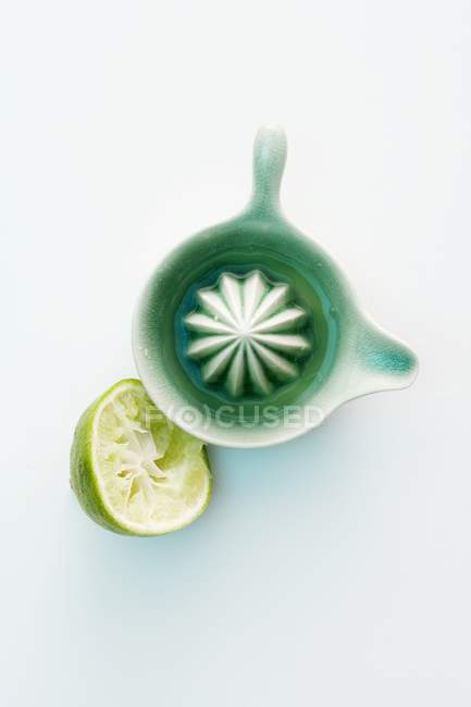 Half of lime and citrus press — Stock Photo