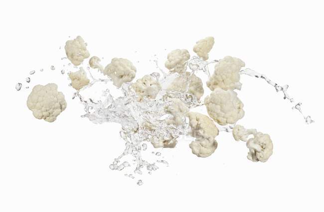 Cauliflower florets and splash of water — Stock Photo