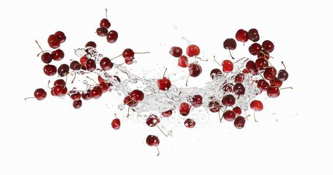 Cherries with splash of water — Stock Photo