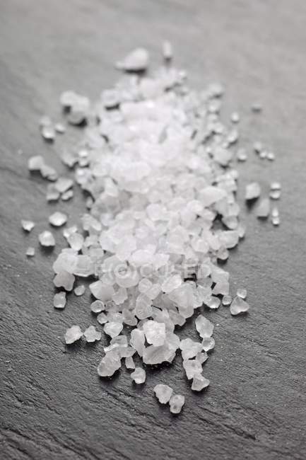 Sea salt on a slate platter — Stock Photo
