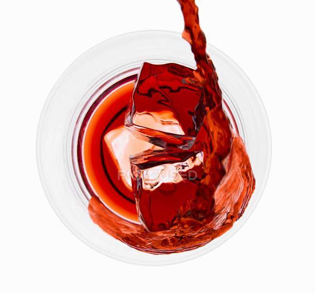 Campari Pooring Over Ice in Glass — стоковое фото