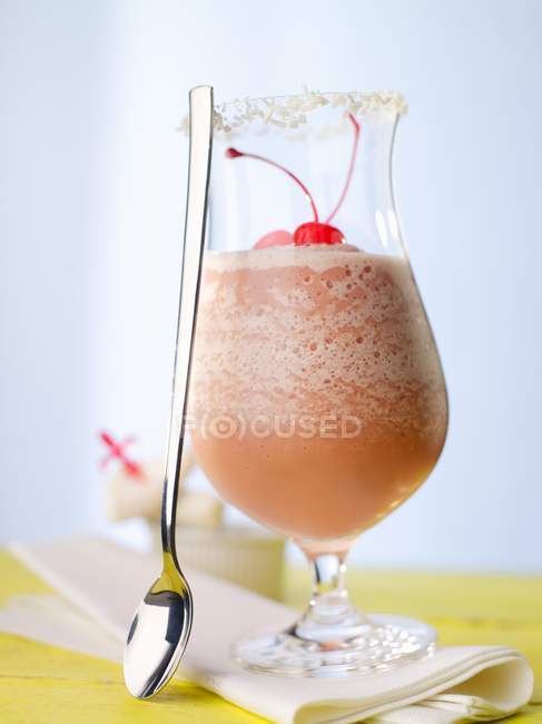 Closeup view of Baileys Girl cocktail with cherries and spoon — Stock Photo