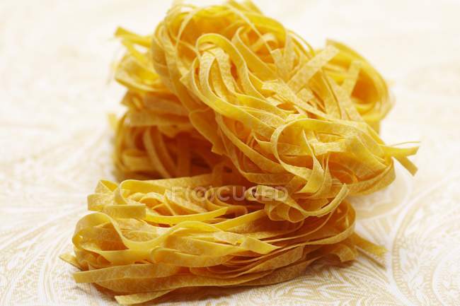 Uncooked fettuccine pasta — Stock Photo