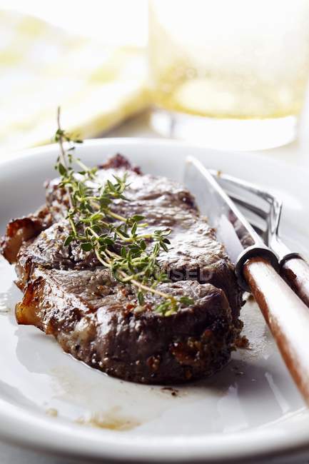 Steak with Sprig of Oregano — Stock Photo
