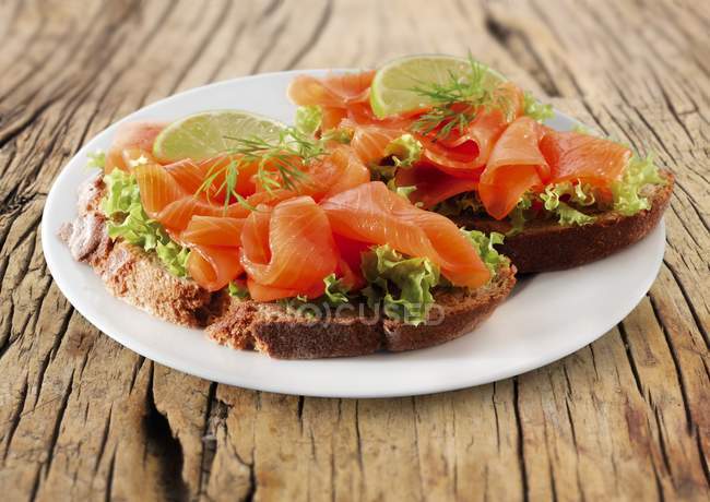 Open face sandwich with smoked salmon — Stock Photo