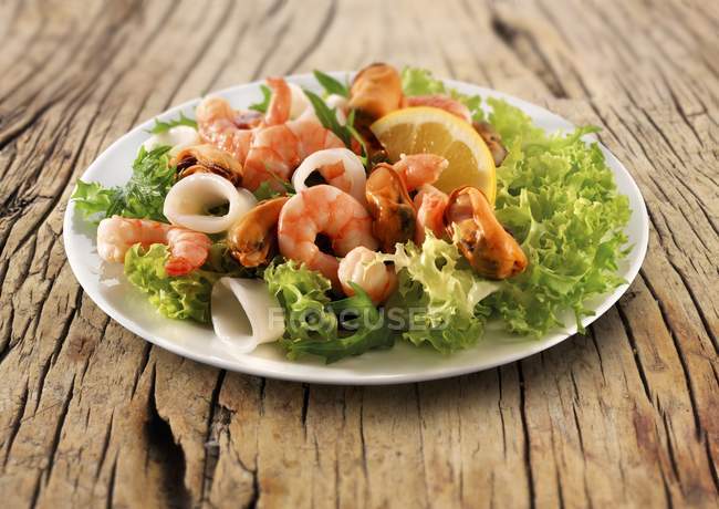 Vista close-up de salada de frutos do mar com camarões e limão no prato — Fotografia de Stock