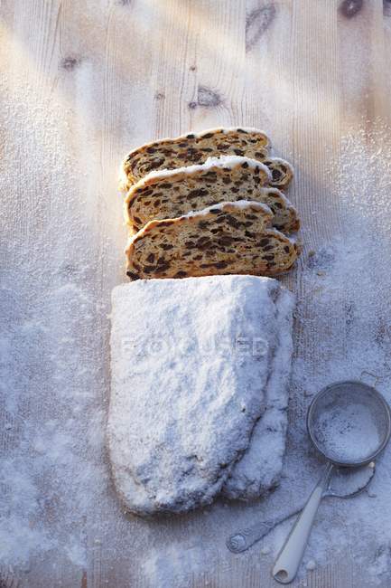 Top view of sliced fruit loaf in icing sugar — Stock Photo