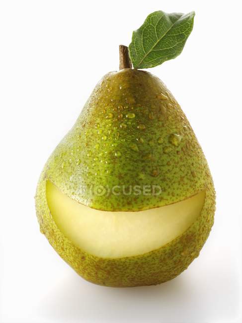 Green pear with slice taken out of it — Stock Photo