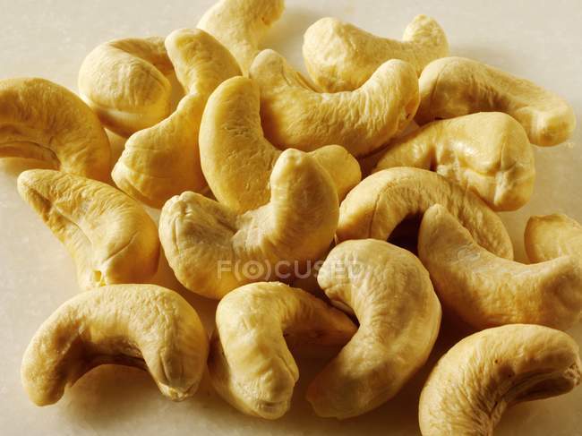 Raw Cashew nuts in heap — Stock Photo