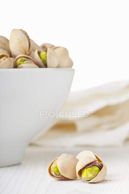 Toasted pistachios on wooden table — Stock Photo