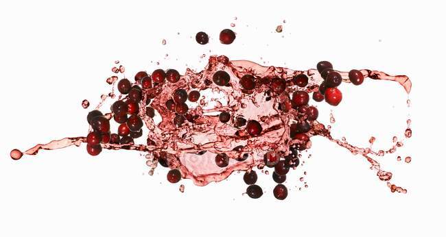 Cranberries with juice splash — Stock Photo