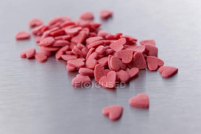 Closeup view of red sugar hearts heap — Stock Photo
