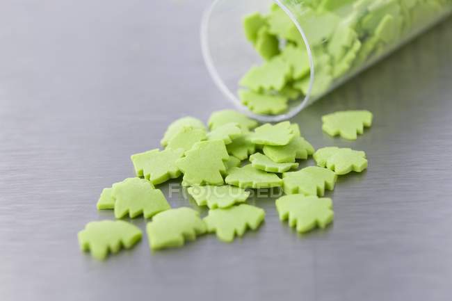 Green tree-shaped sugar cake decorations — Stock Photo